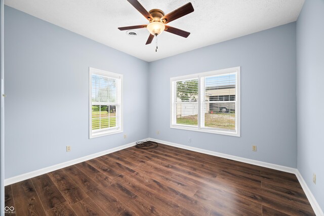 5439 E Kinderhook Rd, Scottsburg, IN 47170 - empty room featuring healthy amount of natural light, dark wood-style flooring, baseboards, and ceiling fan