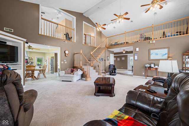 5439 E Kinderhook Rd, Scottsburg, IN 47170 - carpeted living area featuring ceiling fan, stairs, high vaulted ceiling, baseboards, and beamed ceiling