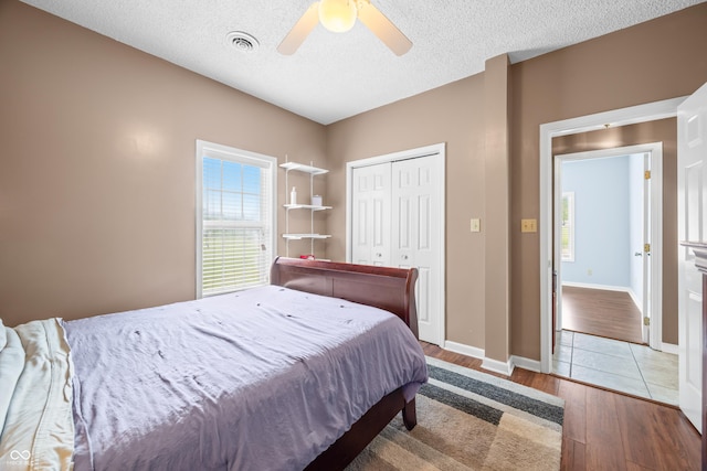 5439 E Kinderhook Rd, Scottsburg, IN 47170 - bedroom featuring wood finished floors, a closet, ceiling fan, a textured ceiling, and baseboards
