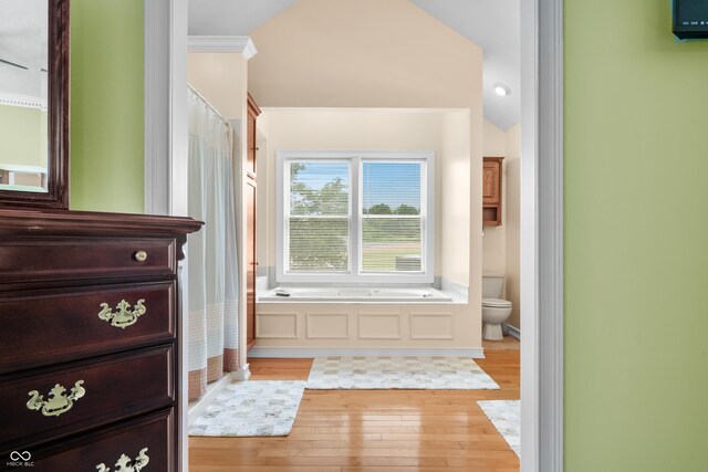 5439 E Kinderhook Rd, Scottsburg, IN 47170 - bathroom featuring hardwood / wood-style flooring, toilet, a bath, and ornamental molding