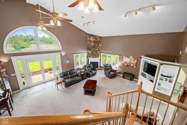 5439 E Kinderhook Rd, Scottsburg, IN 47170 - tiled living room featuring high vaulted ceiling, ceiling fan, rail lighting, a fireplace, and carpet floors