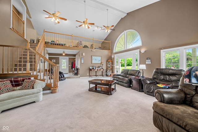 5439 E Kinderhook Rd, Scottsburg, IN 47170 - carpeted living room featuring a ceiling fan, high vaulted ceiling, stairway, and plenty of natural light