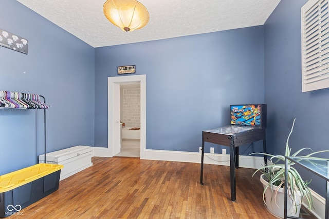 245 S Washington St, Danville, IN 46122 - office area featuring hardwood / wood-style floors, baseboards, and a textured ceiling