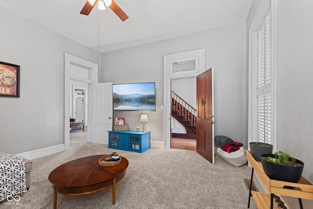245 S Washington St, Danville, IN 46122 - living area with carpet, a ceiling fan, a textured ceiling, baseboards, and stairway