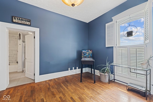 245 S Washington St, Danville, IN 46122 - misc room with hardwood / wood-style floors, baseboards, and a textured ceiling