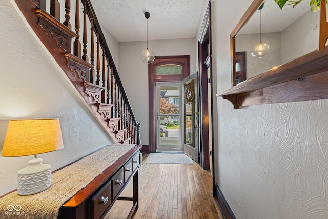 245 S Washington St, Danville, IN 46122 - entryway with hardwood / wood-style floors, stairs, a textured ceiling, and baseboards