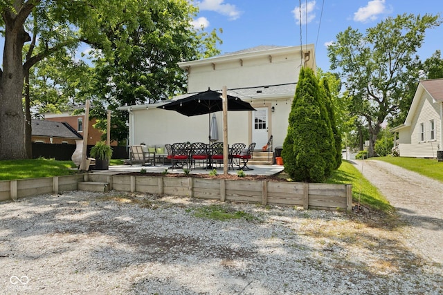 245 S Washington St, Danville, IN 46122 - back of property with a patio area, stucco siding, and entry steps