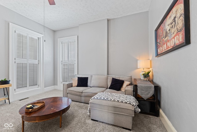 245 S Washington St, Danville, IN 46122 - carpeted living room featuring baseboards, a textured ceiling, and ceiling fan
