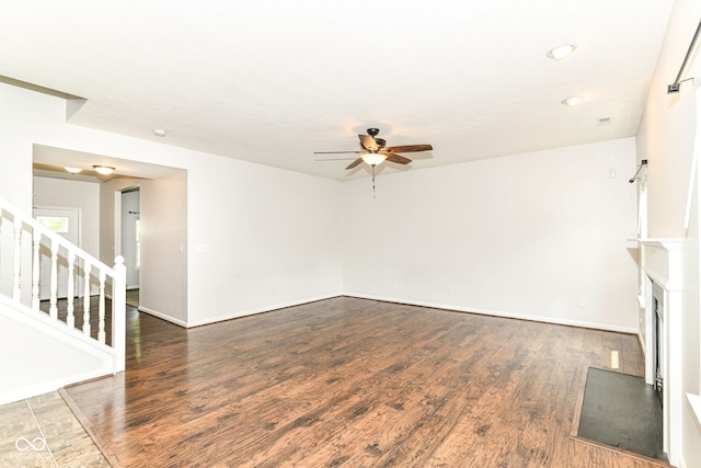 4650 Blue Marlin Way, Indianapolis, IN 46239 - unfurnished living room with a ceiling fan, stairway, wood finished floors, and a fireplace