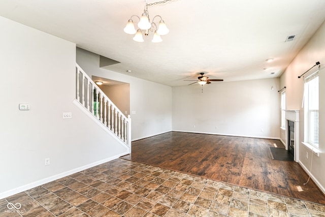 4650 Blue Marlin Way, Indianapolis, IN 46239 - unfurnished living room featuring a chandelier, stone finish flooring, stairs, and ceiling fan