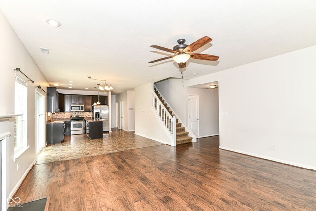 4650 Blue Marlin Way, Indianapolis, IN 46239 - unfurnished living room featuring stairway, dark wood-style floors, a ceiling fan, a chandelier, and recessed lighting