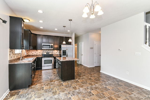4650 Blue Marlin Way, Indianapolis, IN 46239 - kitchen featuring appliances with stainless steel finishes, stone finish floors, a chandelier, backsplash, and recessed lighting