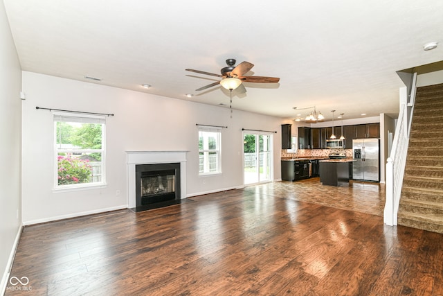 4650 Blue Marlin Way, Indianapolis, IN 46239 - unfurnished living room featuring stairway, plenty of natural light, ceiling fan, and dark wood finished floors
