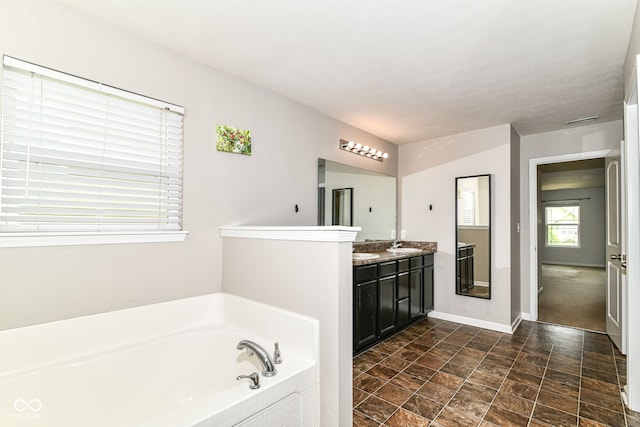 4650 Blue Marlin Way, Indianapolis, IN 46239 - bathroom with a bath, double vanity, and stone finish flooring