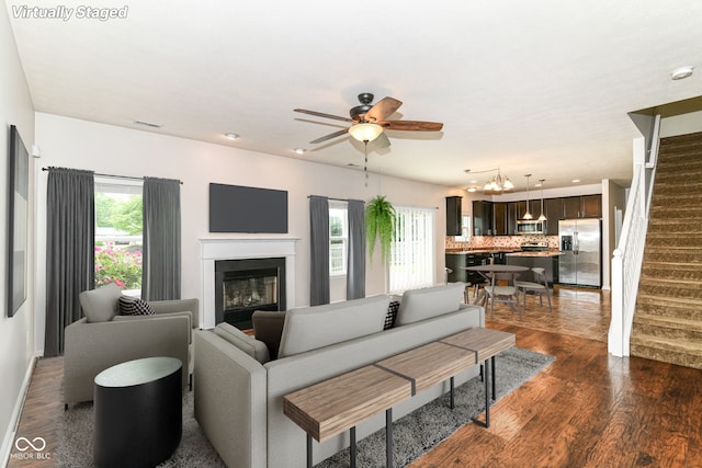 4650 Blue Marlin Way, Indianapolis, IN 46239 - living room featuring stairs, dark wood-type flooring, ceiling fan, a glass covered fireplace, and recessed lighting