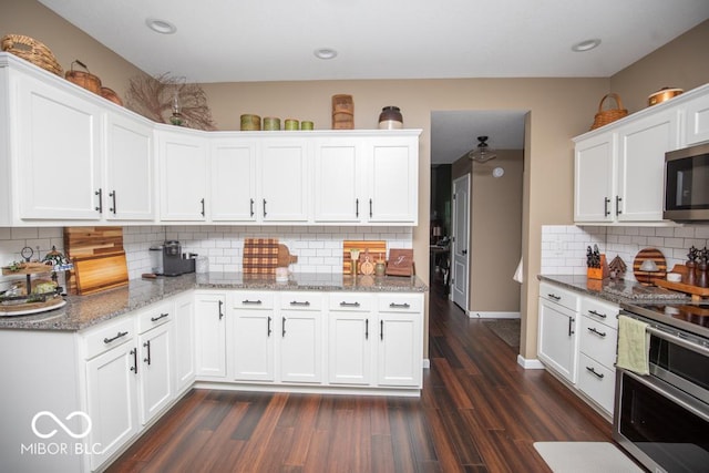 845 S Bay, North Vernon, IN 47265 - kitchen featuring stainless steel appliances, tasteful backsplash, white cabinetry, dark wood-style flooring, and recessed lighting