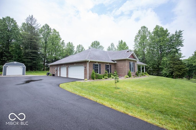 845 S Bay, North Vernon, IN 47265 - ranch-style house with brick siding, a front yard, an outbuilding, and an attached garage