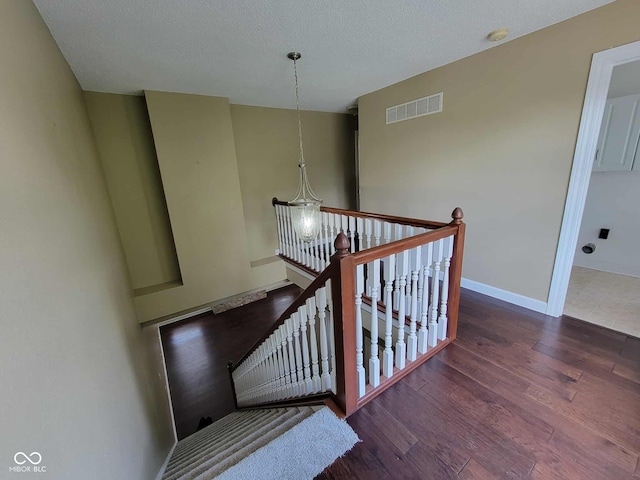 11070 Long Lake Ln, Fishers, IN 46037 - stairway featuring wood finished floors, a textured ceiling, and baseboards