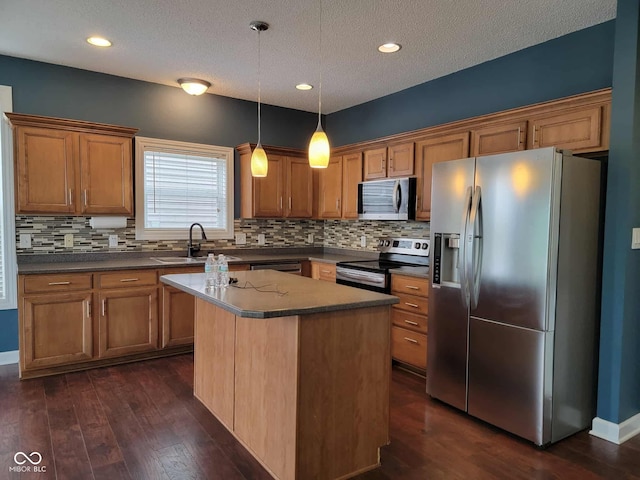 11070 Long Lake Ln, Fishers, IN 46037 - kitchen with appliances with stainless steel finishes, a sink, decorative backsplash, brown cabinets, and a textured ceiling