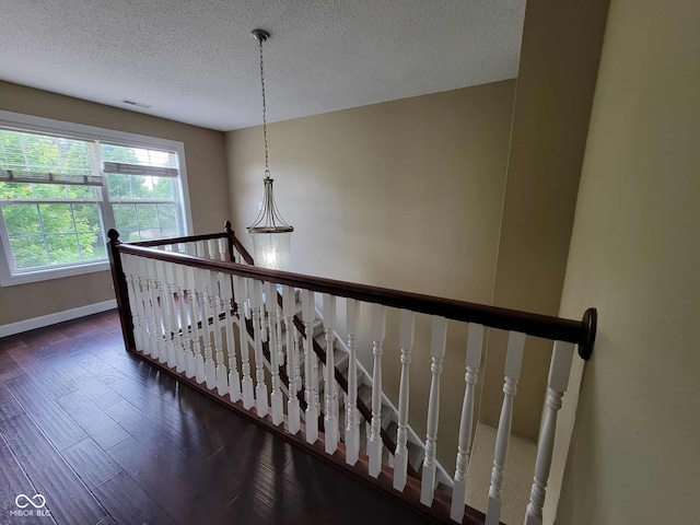11070 Long Lake Ln, Fishers, IN 46037 - stairway featuring wood finished floors, a textured ceiling, and baseboards
