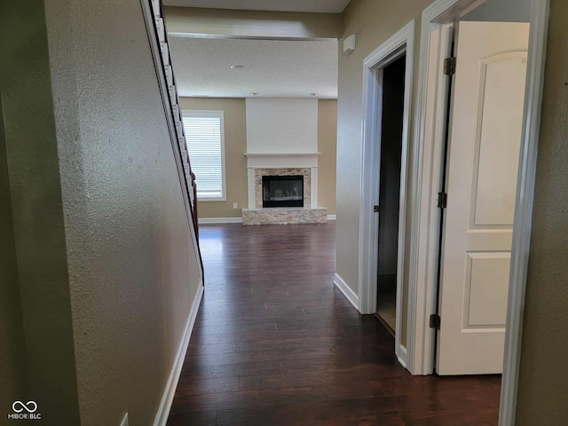 11070 Long Lake Ln, Fishers, IN 46037 - hallway with dark wood-style flooring, a textured wall, and baseboards