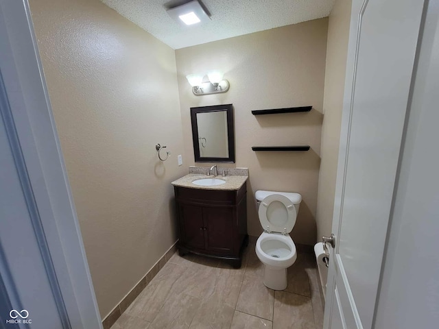 11070 Long Lake Ln, Fishers, IN 46037 - bathroom with vanity, toilet, a textured wall, baseboards, and a textured ceiling