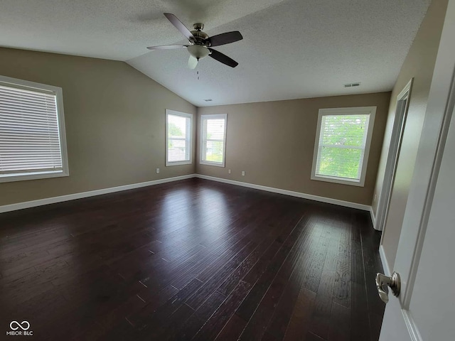 11070 Long Lake Ln, Fishers, IN 46037 - empty room featuring dark wood-type flooring, a ceiling fan, a textured ceiling, vaulted ceiling, and baseboards