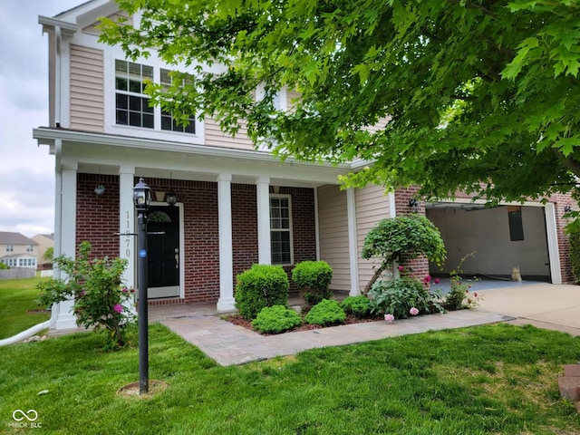 11070 Long Lake Ln, Fishers, IN 46037 - view of front facade featuring brick siding, a front lawn, and covered porch