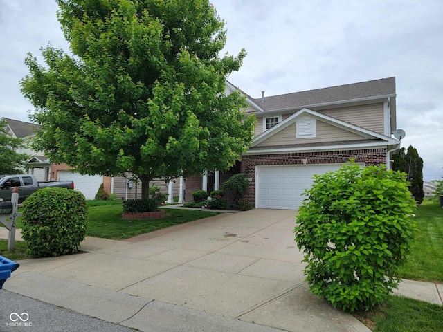 11070 Long Lake Ln, Fishers, IN 46037 - view of front of house with brick siding, driveway, a garage, and a front lawn