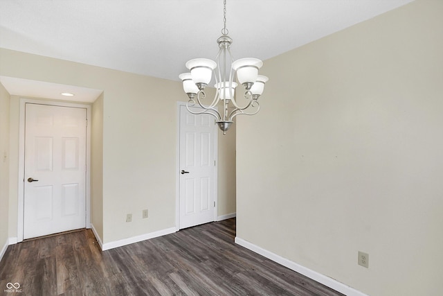 1024 Rotherham Ln, Beech Grove, IN 46107 - spare room with a chandelier, baseboards, dark wood-type flooring, and recessed lighting