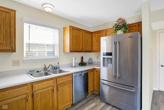 1024 Rotherham Ln, Beech Grove, IN 46107 - kitchen featuring stainless steel appliances, a sink, light wood-style floors, light countertops, and brown cabinets