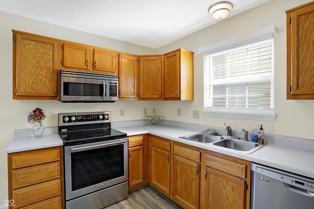 1024 Rotherham Ln, Beech Grove, IN 46107 - kitchen featuring stainless steel appliances, a sink, light countertops, and light wood-style flooring