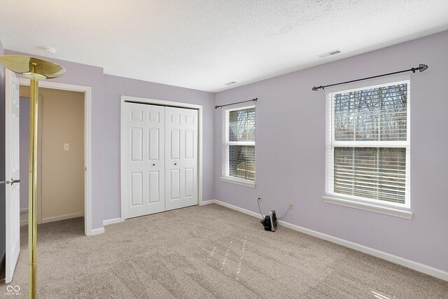 1024 Rotherham Ln, Beech Grove, IN 46107 - unfurnished bedroom featuring carpet, a closet, baseboards, and a textured ceiling