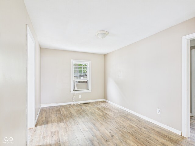 2405 E 9th St, Anderson, IN 46012 - spare room with light wood-style floors, baseboards, and cooling unit