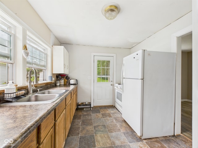 2405 E 9th St, Anderson, IN 46012 - kitchen with white appliances, a sink, brown cabinetry, and dark stone finish floors