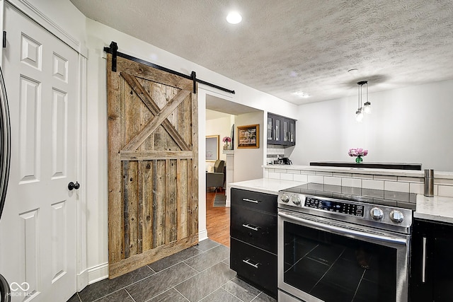1548 N Park Ave, Indianapolis, IN 46202 - kitchen featuring stainless steel range with electric stovetop, dark cabinets, a barn door, and a textured ceiling