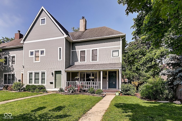 1548 N Park Ave, Indianapolis, IN 46202 - view of front of home featuring a chimney, a porch, a front lawn, and roof with shingles