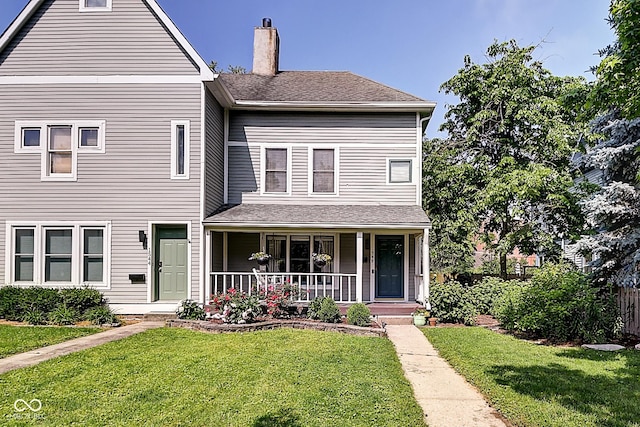 1548 N Park Ave, Indianapolis, IN 46202 - view of front of home with a porch, a chimney, and a front yard