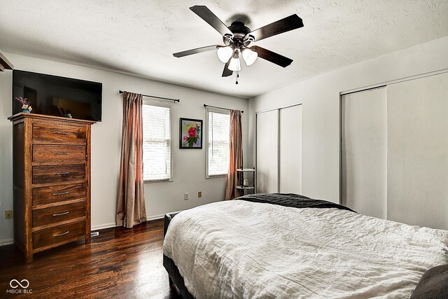 1548 N Park Ave, Indianapolis, IN 46202 - bedroom featuring two closets, wood finished floors, baseboards, ceiling fan, and a textured ceiling