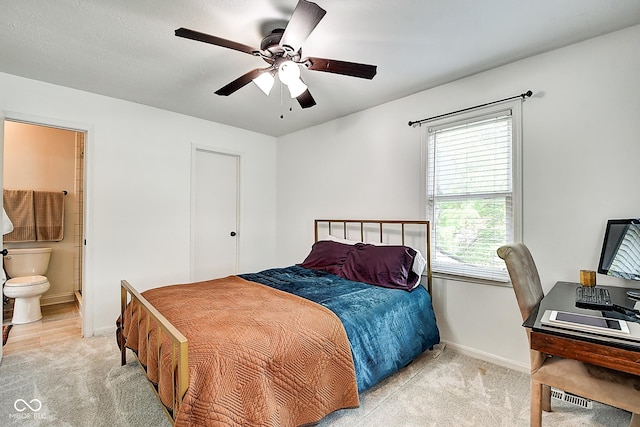 1548 N Park Ave, Indianapolis, IN 46202 - bedroom featuring light carpet, baseboards, ensuite bath, an office area, and a ceiling fan