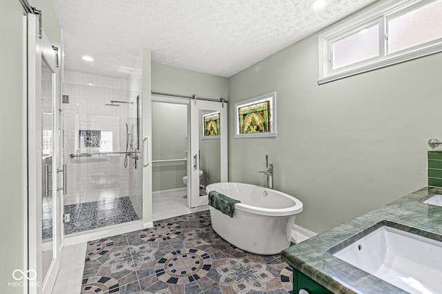 11244 Blackwalnut Pt, Indianapolis, IN 46236 - full bathroom with a shower stall, a freestanding tub, double vanity, a textured ceiling, and recessed lighting