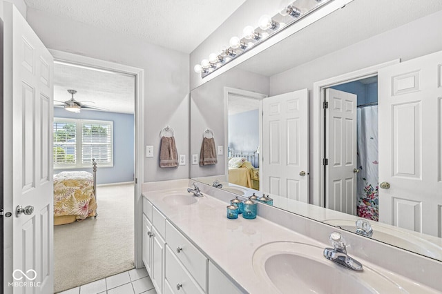 11244 Blackwalnut Pt, Indianapolis, IN 46236 - ensuite bathroom with double vanity, a textured ceiling, tile patterned flooring, and a ceiling fan