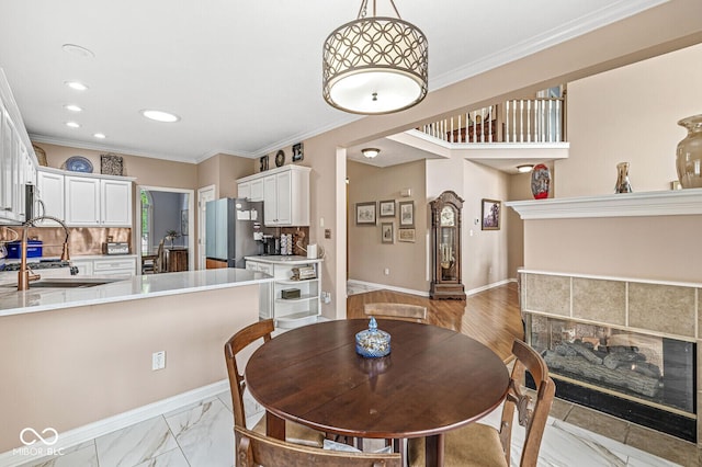 11244 Blackwalnut Pt, Indianapolis, IN 46236 - dining room with recessed lighting, a tiled fireplace, and ornamental molding