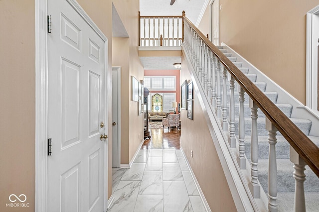 11244 Blackwalnut Pt, Indianapolis, IN 46236 - entrance foyer with light marble finish floors, stairs, and a towering ceiling