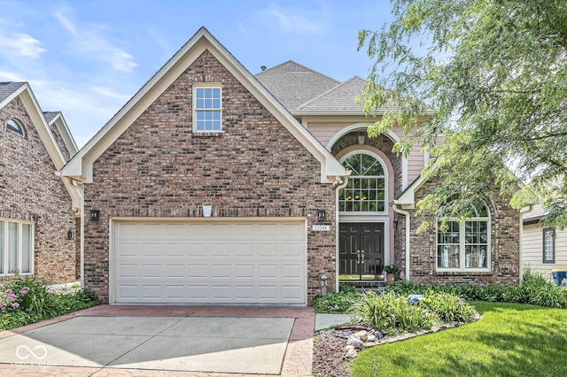 11244 Blackwalnut Pt, Indianapolis, IN 46236 - traditional-style house featuring brick siding, driveway, roof with shingles, and a front lawn