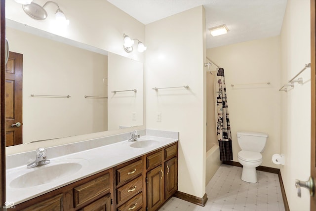 8619 Wrangler Ct, Indianapolis, IN 46217 - bathroom with toilet, double vanity, tile patterned floors, baseboards, and shower / tub combo with curtain
