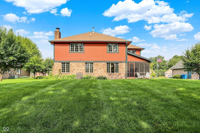 8619 Wrangler Ct, Indianapolis, IN 46217 - rear view of property with a sunroom, a chimney, a lawn, brick siding, and a shingled roof
