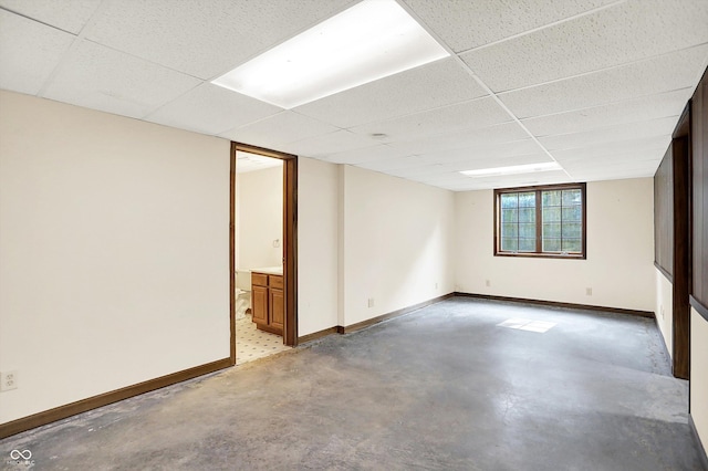 8619 Wrangler Ct, Indianapolis, IN 46217 - spare room featuring concrete floors, baseboards, and a drop ceiling