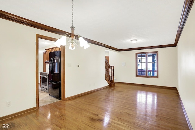 8619 Wrangler Ct, Indianapolis, IN 46217 - unfurnished room featuring crown molding, light wood-style floors, a chandelier, stairs, and baseboards