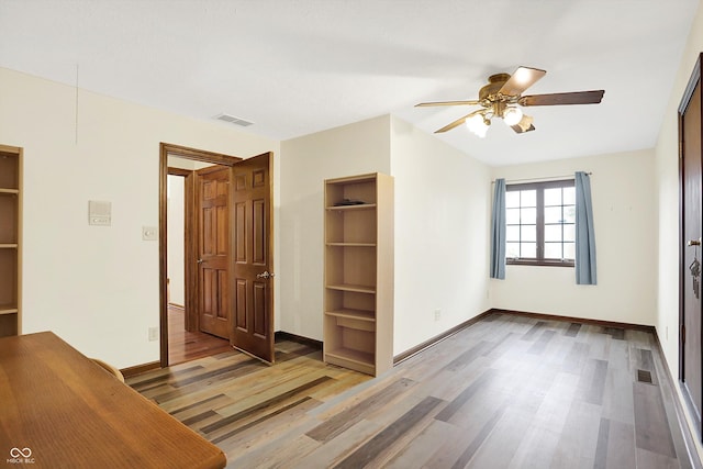 8619 Wrangler Ct, Indianapolis, IN 46217 - unfurnished bedroom featuring wood finished floors, baseboards, and a ceiling fan